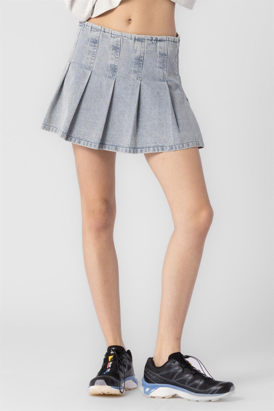 Pleated denim mini skirt.