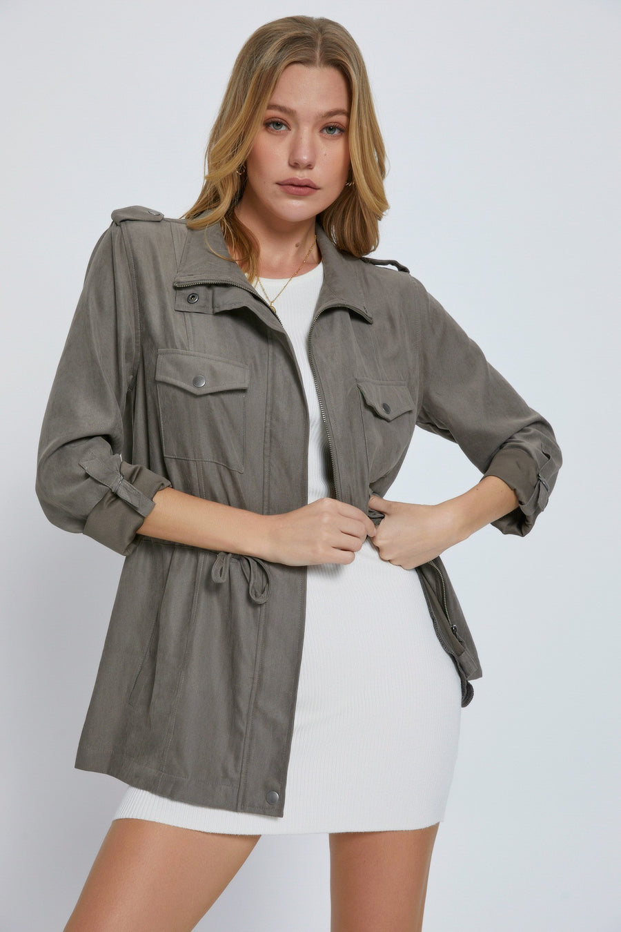 Grey utility jacket with drawstring at waist and cuffed sleeves.