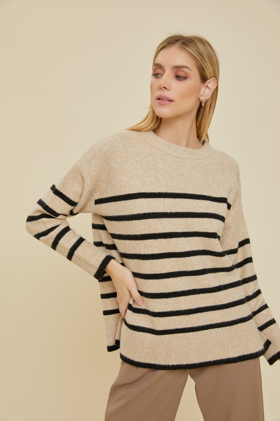 Striped sweater in the color beige.