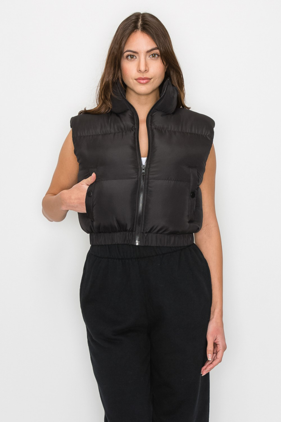 Black puffer vest with side pockets and collared neck. 
