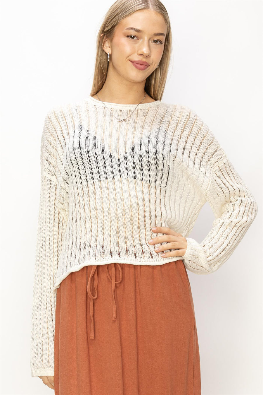 Whip cream colored long sleeve knitted top with drop sleeves and a round neck. 