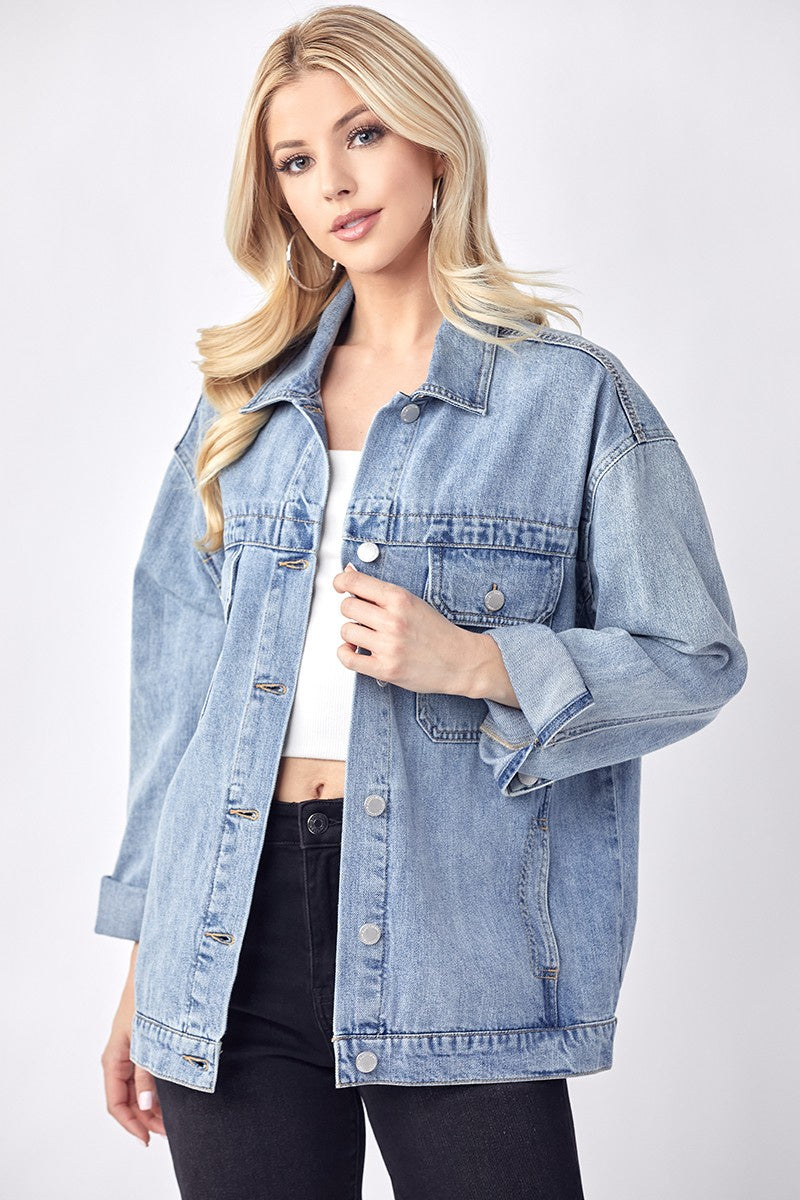 Featuring an oversized denim jacket with a front pockets and button up closure.