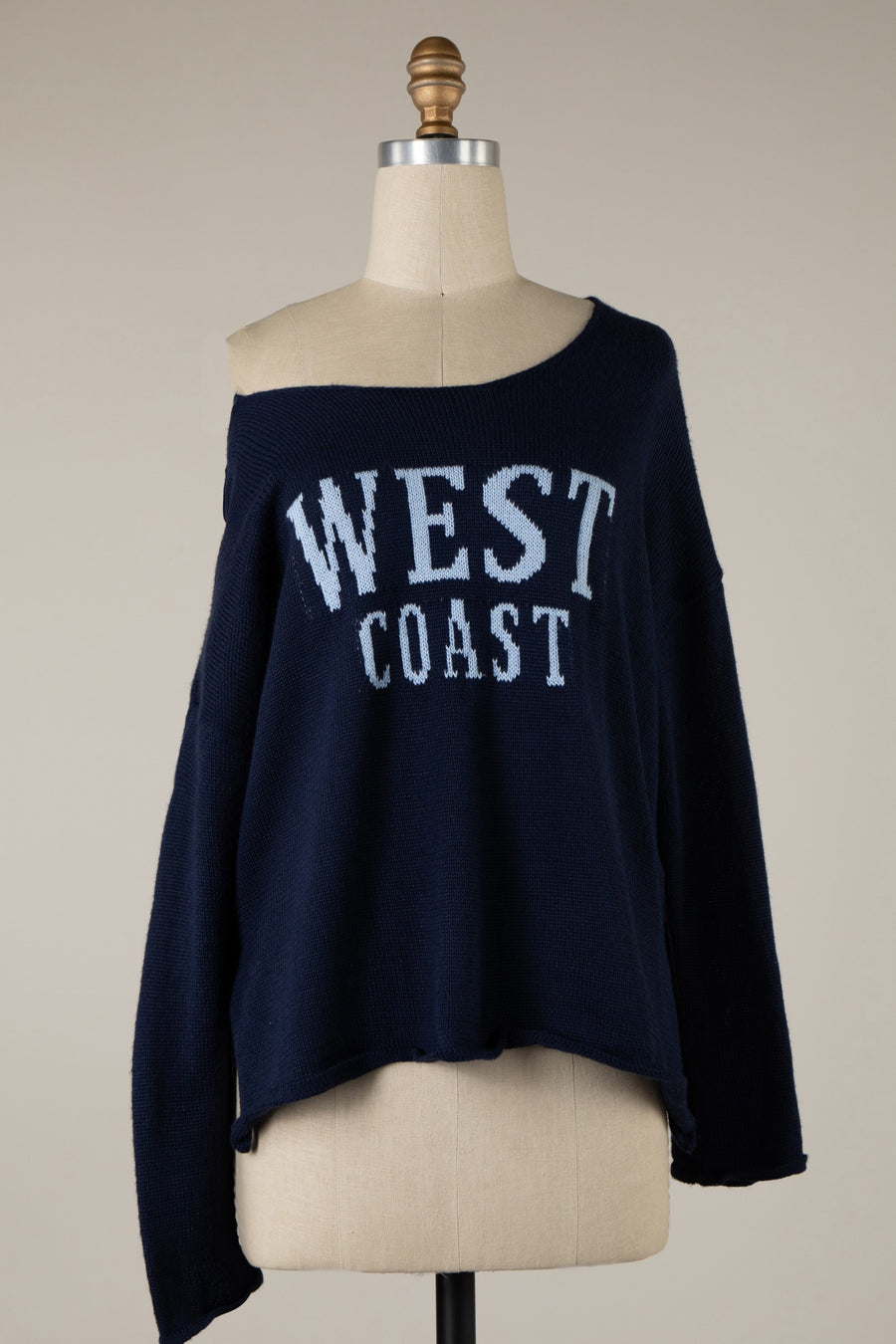 Featuring a light weight sweater with "West Coast" on the frontand a wide neckline.