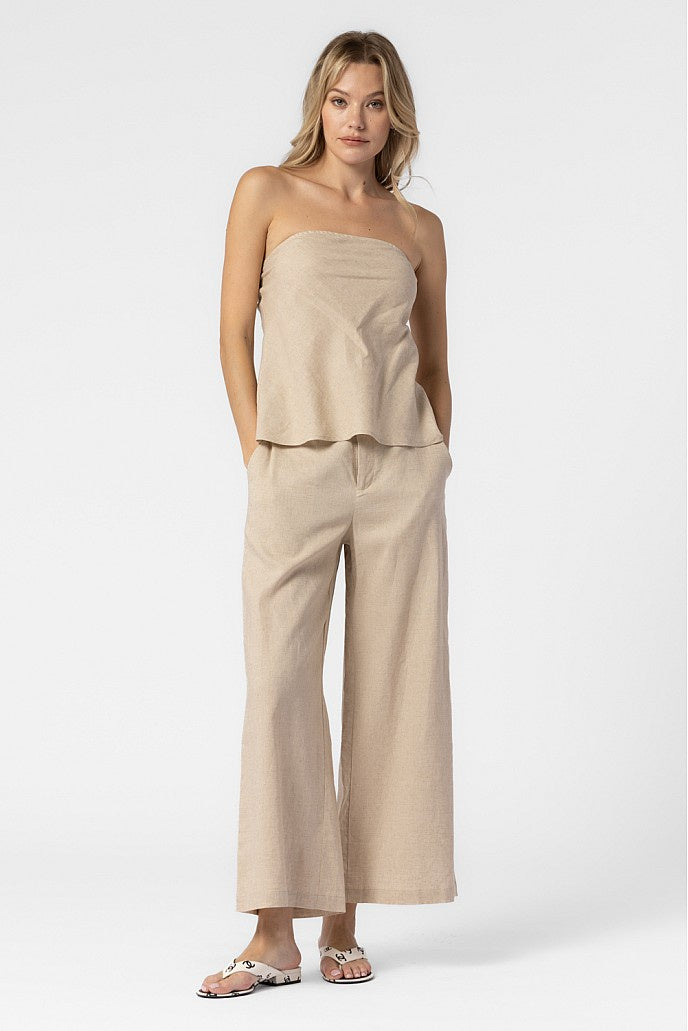 Featuring a strapless linen top with a slitted back detail in the color oat