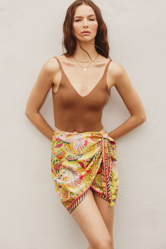 Paisley border print mini wrap skirt with tassel details. 100% Polyester 