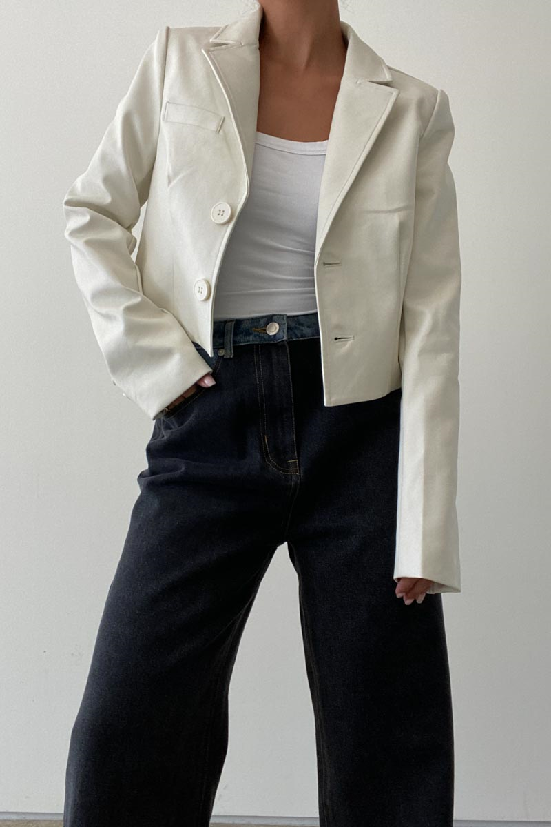 Featuring a double button blazer in the color cream