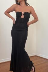 Featuring a fitted floor length strapless maxi dress with open front detail in the color black