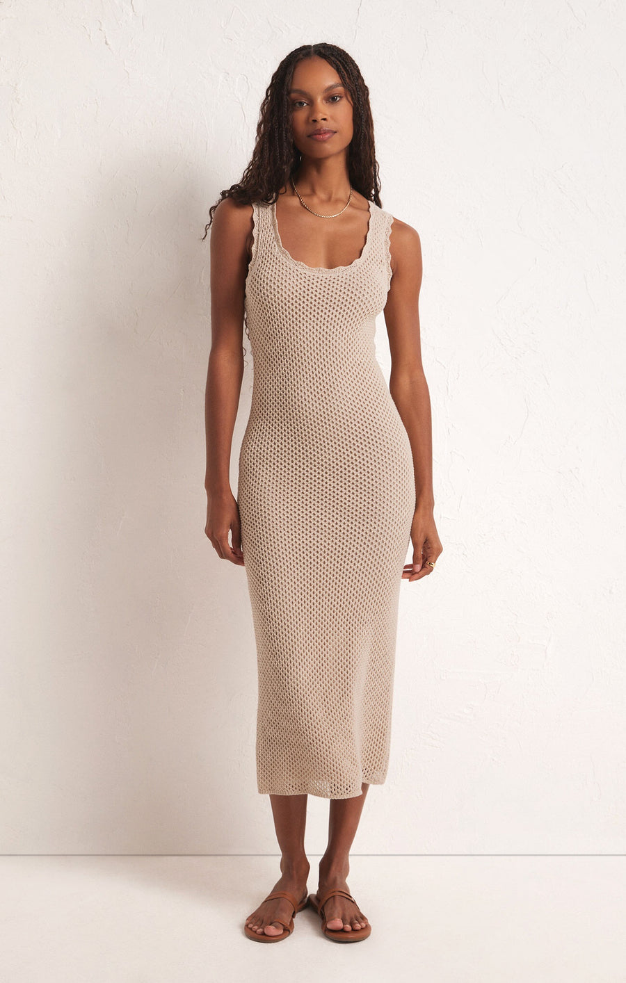 Featuring a sleeveless knitted scoopneck midi dress in the color natural 
