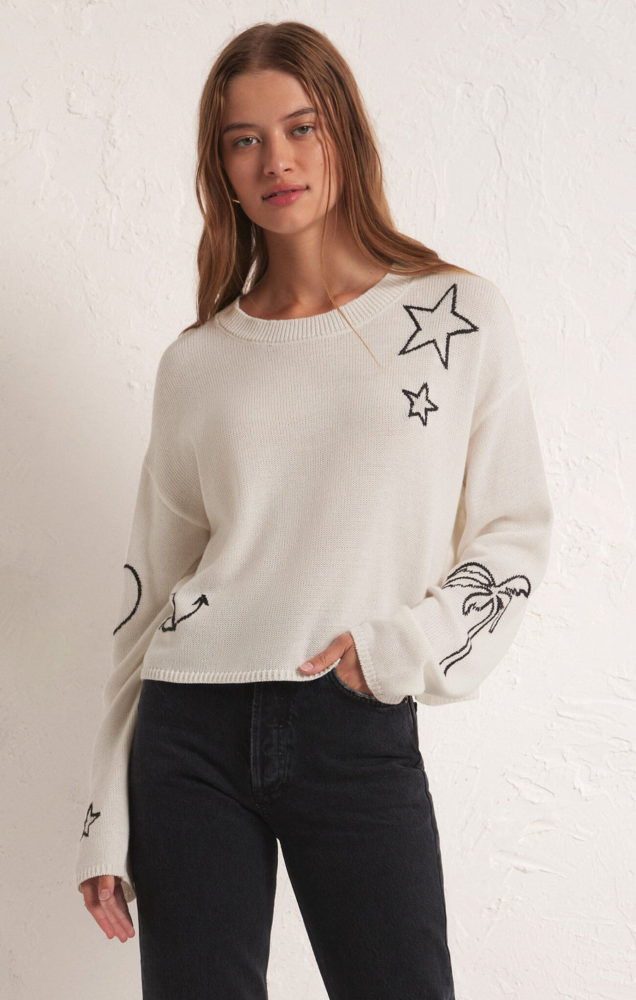 Sweater with intarsia designs in white.